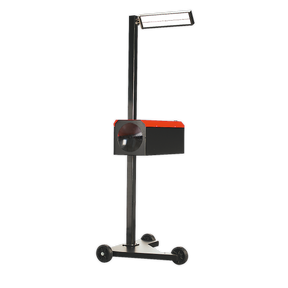 Introducing the Sealey HBS2001 Workshop Headlamp Beam Setter, a black and red portable floodlight with a large lamp at the top, mounted on a three-wheeled base for easy movement—ideal for precise light intensity measurement.