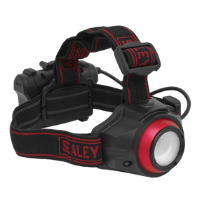 The Sealey Rechargeable Head Torch 5W COB LED Auto-Sensor - HT111R is a black and red headlamp featuring an adjustable headband and a large front light. The strap, adorned with the brand name "Sealey" in red, ensures a secure fit. This hands-free LED spotlight is perfect for any task requiring both hands.
