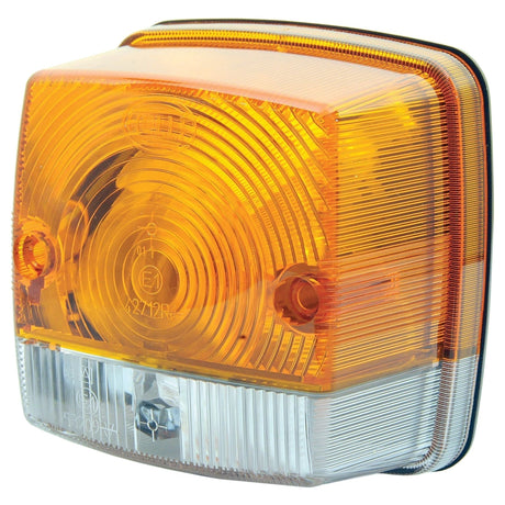 Close-up of a rectangular Sparex Front Combination Light (Halogen), 12/24V, RH & LH, Straight - S.56133 with a yellow upper section and a clear lower section, featuring a textured surface and mounting screws. The halogen light ensures high visibility, meeting IP5K9K standards.