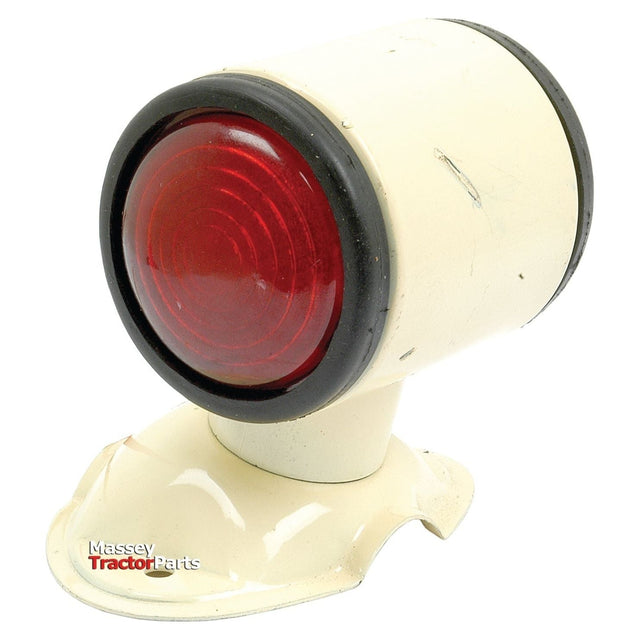 Close-up of a vintage white Side Light - Front/Rear (Halogen), RH, 12V - S.43152 by Sparex with a red lens on a solid white background, showing slight signs of wear. The words "Massey Tractor Parts" are printed near the base, encased in a sturdy metal housing.