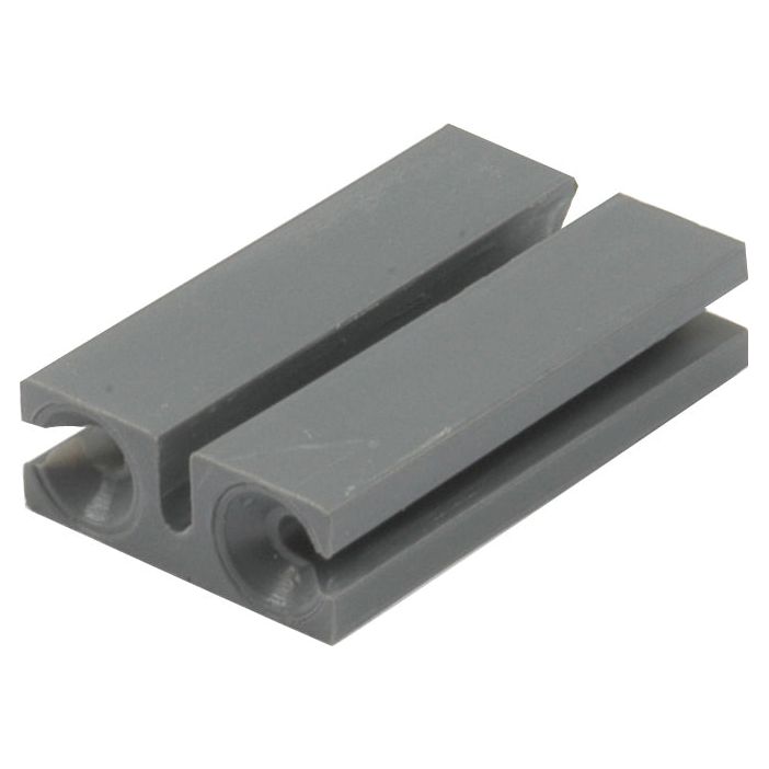 A close-up image of a small, rectangular, gray plastic component with two parallel, U-shaped channels, perfect for fitting into the Hand Throttle Cable (Sparex Part No. S.42191) from the Sparex NLA brand for Massey Ferguson throttle cable systems.