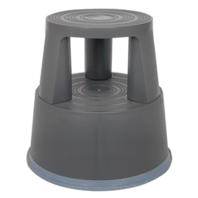 Introducing the Sealey Kick-Step Composite - KS4, a gray plastic step stool featuring a round base with three legs and spring-loaded wheels for effortless mobility. Crafted from heavy-duty composite materials, it provides added height and stability along with a non-slip surface for enhanced safety.