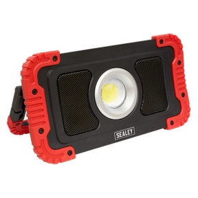 A rectangular Sealey Rechargeable Wireless Speaker Work Light, featuring a central 20W COB LED floodlight, with a black body and red protective corners.