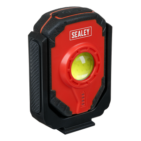 The Sealey Rechargeable Worklight 15W COB LED - LED315 is a compact worklight with a red and black casing, featuring a yellow lens in the center and a textured grip on the side. This 360° rotatable LED light also includes an emergency power bank function for added convenience.