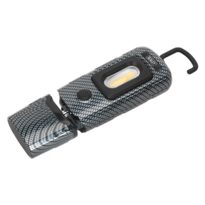 The Sealey Rechargeable 360° Inspection Light, model LED3601CF, features a compact and lightweight design with a carbon fibre effect. This gray portable LED light includes a hook attachment and a small control button, designed with a textured finish. Equipped with both a super bright 3W COB LED and 1W SMD LED, it offers versatile use in any situation thanks to its 360° swivel tilt capability.