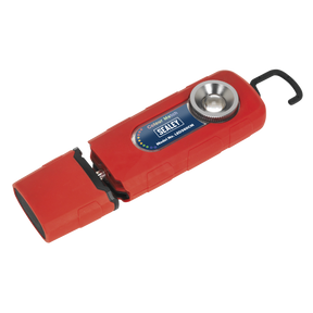 An image of the Sealey 360° Rechargeable Inspection Light 5W COB LED Colour Match CRI 96 - 3-Colour, featuring a red, handheld design with a hook attachment and a circular LED lamp on one end. The high CRI light includes a sliding cover and is labeled "Colour Match.