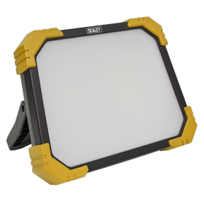 The Sealey Site Light 48W SMD LED - 110V (model LED48110) is a rectangular floodlight with a heavy-duty design featuring a black frame and yellow corner guards. Supported by a stand, this powerful unit delivers ultra-bright illumination for all your lighting needs.