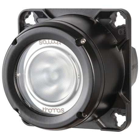 A round, dark-colored industrial device with a clear front lens is mounted on a square base featuring screw holes at each corner. The lens displays the text "Thomas" and "SONJA." This Sparex LED Work Light (Cree High Power) incorporates an integrated 2-pin Deutsch connector and is rated IP68 for durability.