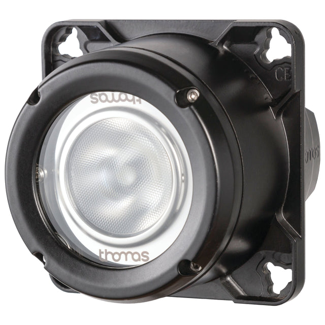 A round, dark-colored industrial device with a clear front lens is mounted on a square base featuring screw holes at each corner. The lens displays the text "Thomas" and "SONJA." This Sparex LED Work Light (Cree High Power) incorporates an integrated 2-pin Deutsch connector and is rated IP68 for durability.