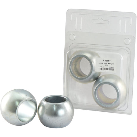 Three metallic spherical bushings, including the Sparex Lower Link Ball (Cat. 3/3) - S.23007 made of 20Mncr5 Steel with a 1 7/16'' inner diameter, are shown with one placed in front of its clear plastic packaging. The packaging includes a label with text.