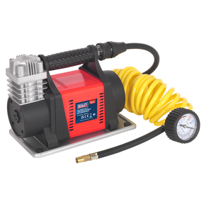 The Sealey MAC05 Tyre Inflator/Mini Air Compressor 12V Heavy-Duty features a red body, black handle, and an integrated gauge. It comes equipped with a yellow coiled hose and a pressure gauge attached to the hose, making it perfect for inflating tyres using its 12V battery.