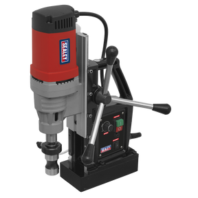 The Sealey Magnetic Drilling Machine 60mm 230V - MAG60230V features a red and black body, high-quality components, adjustable handles, control buttons, and a visible power cord. This durable tool is equipped with an integrated coolant system for optimal performance.