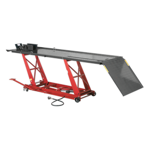 The Sealey Motorcycle Lift MC401A, with a 454kg capacity, features a vibrant red design and diamond plate surface. It includes an air/hydraulic lifting system, wide ramp for easy access, and integrated safety lock device.