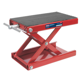 A scissor stand for motorcycles, model MC5908 by Sealey, featuring a red frame, black platform, ball-bearing rollers, and a manual crank handle.