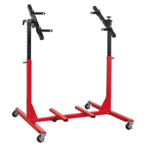 The Sealey Engine Rebuild Stand - Multi-Cylinder 75kg Capacity - MES02 is a red and black stand featuring four swivel casters and adjustable supports for multi-cylinder engines.