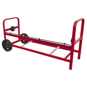 The Sealey Polymask/Masking Paper Dispenser (Model MK77) is equipped with a red wheeled cart, featuring a black axle in the center and handles on both ends. It is designed to carry long objects, such as 900mm rolls, ensuring easy maneuverability and effortless transport.
