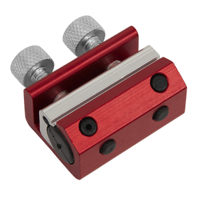 The Motorcycle Twin-Clamp Cable Oiler - MS038 by Sealey is a compact red and silver metal tool that features two knurled adjustment knobs and four screws, specifically designed for twin-clamp cable oiler applications on motorcycle cables.