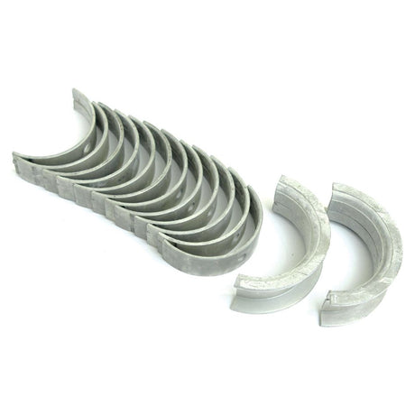 A set of metal engine bearings, the Main Bearing Std. (Set) by Sparex (Part No.S.57656), compatible with International Harvester models, arranged in a curved pattern on a white background.