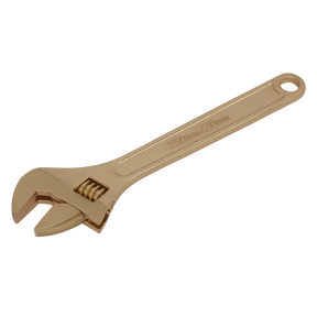 A gold-colored, non-sparking beryllium copper adjustable wrench (250mm) with a hole at the handle's end, branded as Sealey's NS067.
