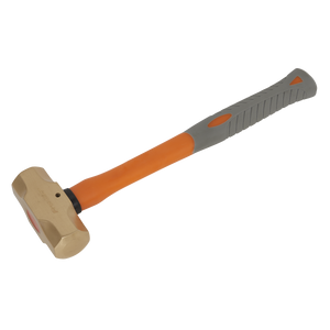 This image showcases the Sealey Sledge Hammer 2.2lb - Non-Sparking - NS087, featuring a sturdy metal head and a dual-colored handle with vibrant orange and gray accents. The design includes a shock-absorbing rubber grip to enhance safety during use.