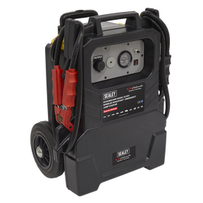 A mobile car battery charger featuring a digital display, control panel, and attached heavy-duty clamps is shown. The device, labeled "Schumacher® Wheeled RoadStart® Emergency Jump Starter 12/24V 1500hp - PBIW6200" from Sealey, can efficiently jump-start diesel vehicles and AGM batteries. Mounted on wheels for portability, it ensures convenience on the go.