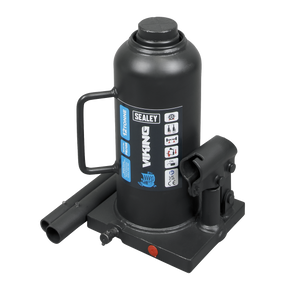 The Sealey Bottle Jack 12 Tonne - PBJ12S is a black hydraulic jack with a capacity label reading "12 Tonne" and various safety symbols. It includes a 2-piece handle, a sturdy machine-welded frame, and an overload valve for added safety.