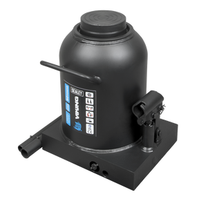 A black Sealey Bottle Jack 50 Tonne - PBJ50S on a flat base, featuring a 2-piece handle, safety labels, and an overload valve.