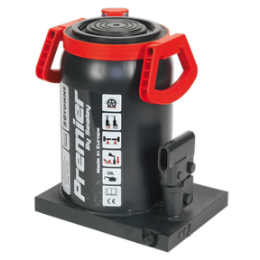 The Premier Bottle Jack 50 Tonne - PBJ50 by Sealey features red handles, a safety overload valve, various safety and operating instruction labels on its body, and is mounted on a flat base.