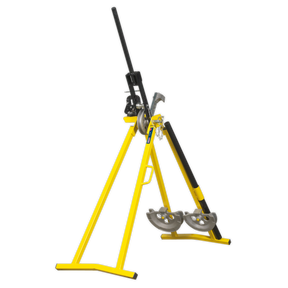 The Sealey Professional Conduit Bender - PCB25 is an industrial pipe bender featuring a yellow frame and a black handle, designed to bend metal pipes. Resembling an A-frame conduit bender, this machine is securely mounted on a sturdy triangular stand.