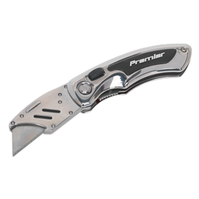 A locking pocket knife with a quick-change blade, presenting a sleek metal body with black accents, branded under the name "Sealey." This cutting-edge tool, from the Sealey Hand Tools lineup, features reversible high carbon steel blades for durability and precision.
