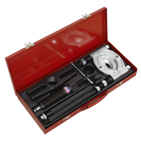 The Sealey Bearing Separator/Puller Set 8pc Hydraulic - PS980 comes in a red metal toolbox and includes a hydraulic puller set with various components, such as a hydraulic cylinder, rods, a puller yoke, and adapters, all organized in foam compartments.