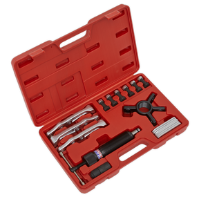 The Sealey Hydraulic Puller Set 19pc - PS981 includes a red plastic tool case with various metal tools, such as wrenches, sockets, and a handle, all neatly arranged in designated slots. This set also features three 3-position puller arms for versatile applications.