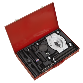 The Sealey PS985 Hydraulic Bearing Separator/Puller Set 10pc comes in a red toolbox and includes an array of mechanical tools such as clamps, bolts, and a hydraulic ram. These tools are neatly organized in foam cutouts.