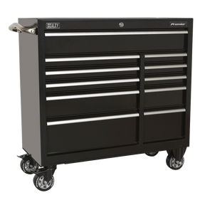 The Sealey Rollcab 11 Drawer 1055mm Heavy-Duty Black - PTB105511 is a black wheeled toolbox featuring heavy-duty welded steel construction, equipped with two handle bars on the sides. It includes eleven drawers: three large and eight smaller ones.