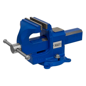 A blue "Sealey" Vice 100mm Quick Action Swivel Base (model QAVE100) made from SG iron, mounted on a flat surface, featuring replaceable steel jaws and a lever handle for convenience and enhanced versatility.