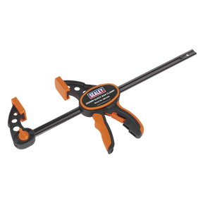 The "Sealey Quick Bar Clamp 300mm - QBC300" is a heavy-duty clamp with a carbon steel bar and a textured TPR grip handle in orange and black.