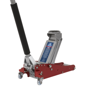 The Sealey Trolley Jack 1.5 Tonne Aluminium/Steel Rocket Lift - RJAS1500 is a red hydraulic floor jack featuring a black handle, four wheels, and a lifting pad. Ideal for motor racing enthusiasts, it boasts a twin piston rocket lift system. Suitable for vehicle maintenance or repairs, the capacity label is clearly visible on the side.