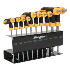The Sealey TRX-Star* Key Set 10pc T-Handle - S01151 consists of 10 black and yellow T-handle hex key wrenches on a metal stand, made from durable Chrome Vanadium steel, labeled with various sizes from T9x100 to T50x100. These wrenches come with a lifetime guarantee for enduring reliability and performance.