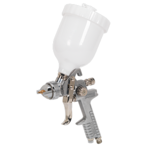 Introducing the Sealey Spray Gun Gravity Feed - 1.4mm Set-Up - S641G, featuring a white top-mounted paint cup, metal handle, and trigger for precise paint flow control, designed to offer a variety of set-up options.