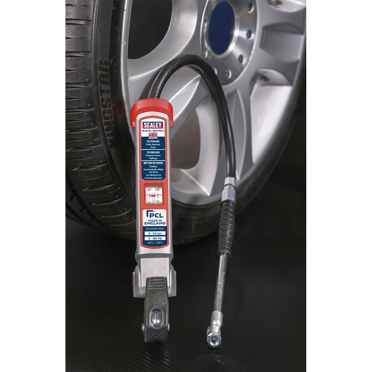 A Sealey Professional Tyre Inflator with Twin Push-On Connector (SA37/93) and an aluminium body and hose is connected to a tire, which is mounted on a car wheel featuring a visible Kingstar brand logo. The inflator's window displays the readings clearly, ensuring accurate pressure scale measurement for optimal performance.