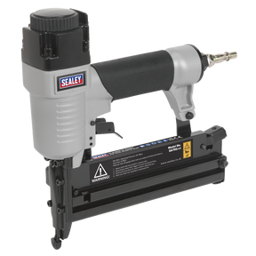 The Sealey Air Nail/Staple Gun SA792, with a 10-50mm nail capacity and a 10-40mm staple capacity, features a black handle, an air hose connector at the end, a built-in safety trigger device for added security, and includes a safety warning.