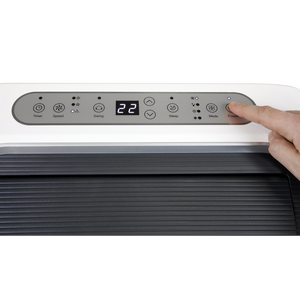 Hand adjusting the temperature on an air conditioner control panel.
