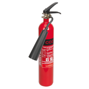 The Sealey Fire Extinguisher 2kg Carbon Dioxide - SCDE02, equipped with a black nozzle and handle, includes a label detailing usage instructions, making it ideal for B Class fires or live electrical components.