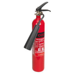 The Sealey Fire Extinguisher 2kg Carbon Dioxide - SCDE02, equipped with a black nozzle and handle, includes a label detailing usage instructions, making it ideal for B Class fires or live electrical components.