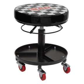 The Sealey Pneumatic Mechanic's Seat - SCR15 features a black adjustable design with a checkered swivel action seat, pneumatic height adjustment, a metal base complete with a tool storage tray, and four red caster wheels for easy mobility.