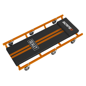 A black and orange mechanic's creeper with a vinyl-covered headrest, padded surface, and six composite castors. The brand name "Sealey" and model "SCR75O" are visible on the surface.