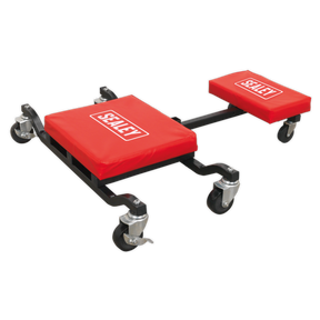 A Sealey Low Level Creeper, Seat & Kneeler - SCR85 features a black metal heavy-duty steel framework with four swiveling caster wheels and red cushioned sections labeled "Sealey." The creeper seat includes a vinyl-covered seat pad for added comfort.