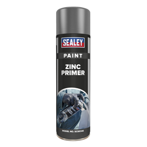 A cylindrical spray can labeled "Sealey Grey Zinc Primer Paint 500ml - SCS034S" with an image of gloved hands using the fast-drying, anti-rust spray on its front.
