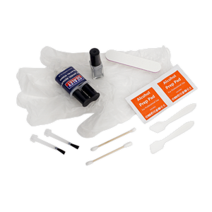 The Alloy Wheel Repair Kit - SCS903 by Sealey includes rubber gloves, two alcohol prep pads, a cleaning brush, small tools, a nail polish bottle, a nail file, and a roll of nail tape to ensure precision akin to curb damage repair.