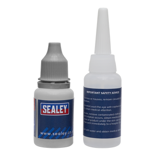 Two bottles from the Sealey-branded Fast-Fix Filler & Adhesive - Grey (SCS909), essential for any adhesive and filler repair system, come equipped with dropper tips and important safety information labels. One bottle features a sealed gray cap, while the other is designed with a long white nozzle attached.